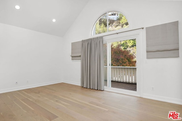 interior space with high vaulted ceiling and light hardwood / wood-style flooring