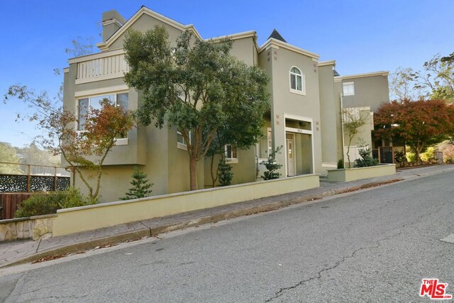 view of side of property featuring a balcony