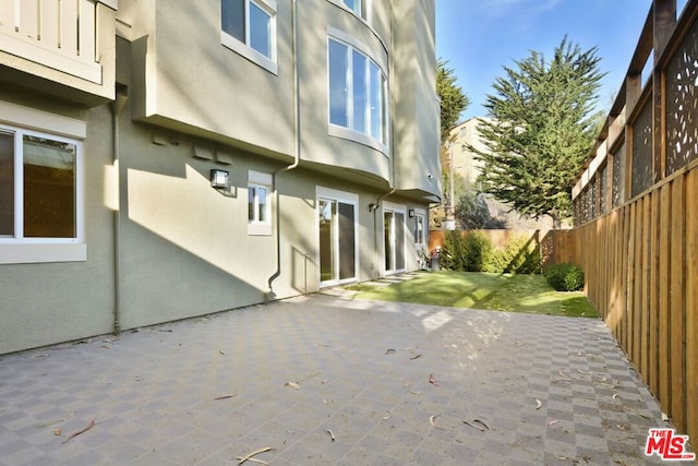 view of side of property with a patio area