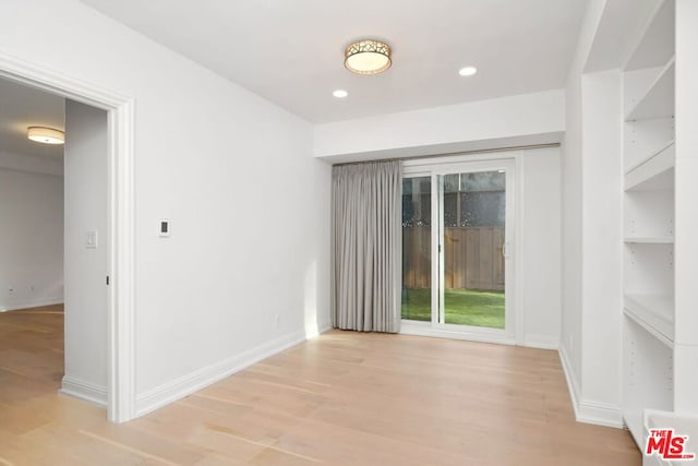 unfurnished room with light wood-type flooring