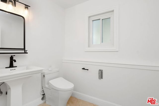 bathroom with tile patterned floors, toilet, and sink