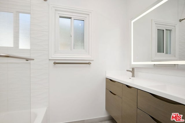 bathroom featuring vanity and tiled shower / bath combo