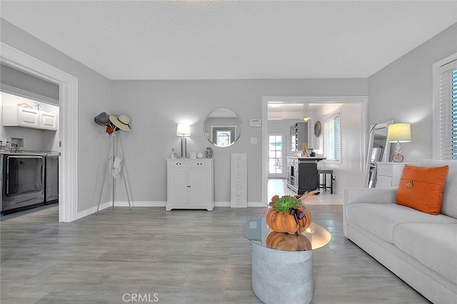 living room featuring light hardwood / wood-style floors and washer / dryer