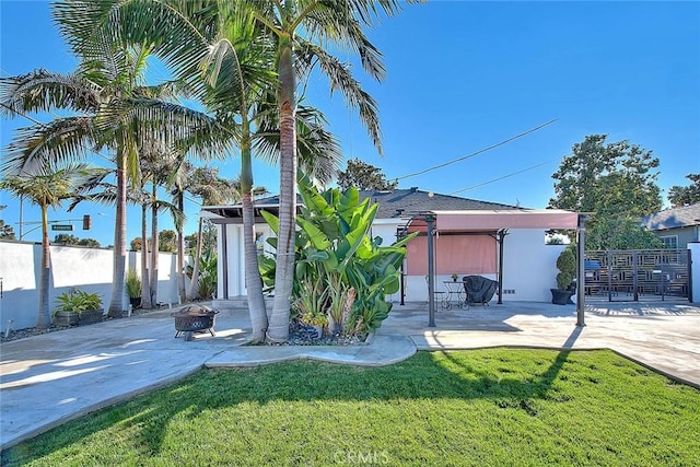 view of yard with a patio and a fire pit