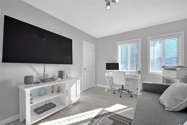 office featuring a textured ceiling and light hardwood / wood-style flooring