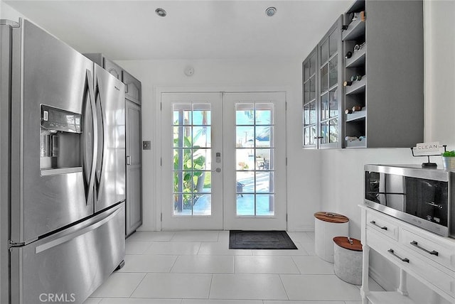 doorway to outside featuring french doors and light tile patterned flooring