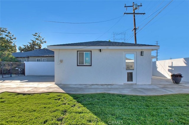 back of property featuring a patio area and a yard