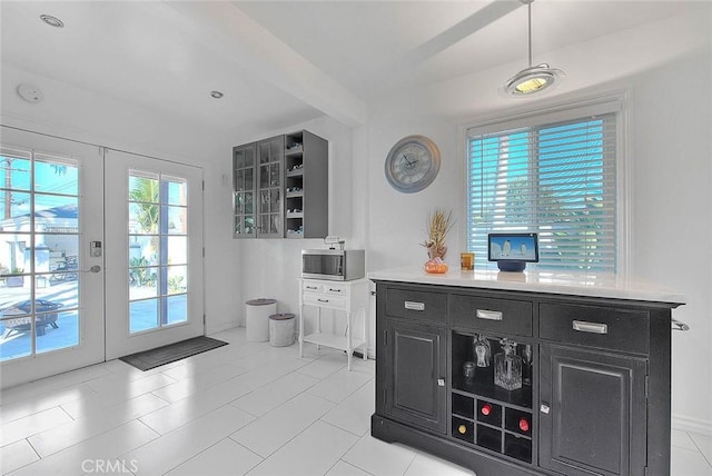 bar with french doors and light tile patterned flooring