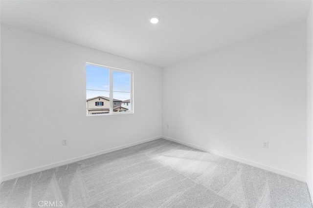 spare room featuring carpet, baseboards, and recessed lighting