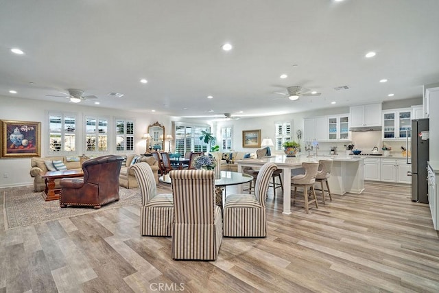 living room with ceiling fan and light wood-type flooring