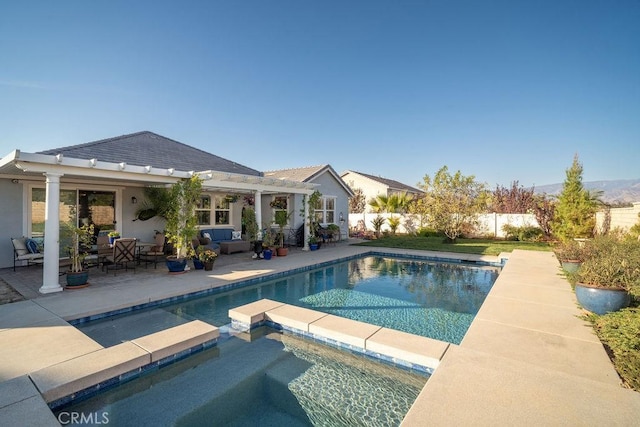 view of swimming pool featuring an in ground hot tub, a patio, and an outdoor hangout area