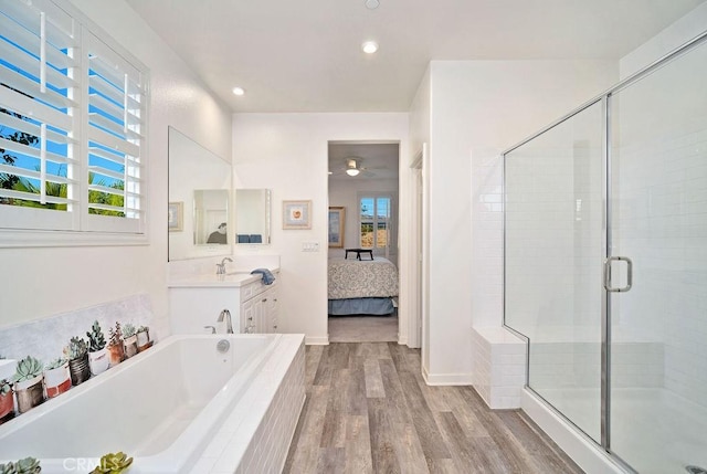 bathroom featuring independent shower and bath, plenty of natural light, vanity, and wood-type flooring