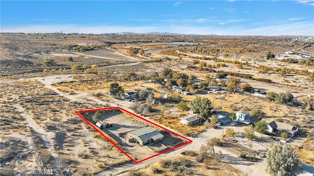 birds eye view of property featuring view of desert