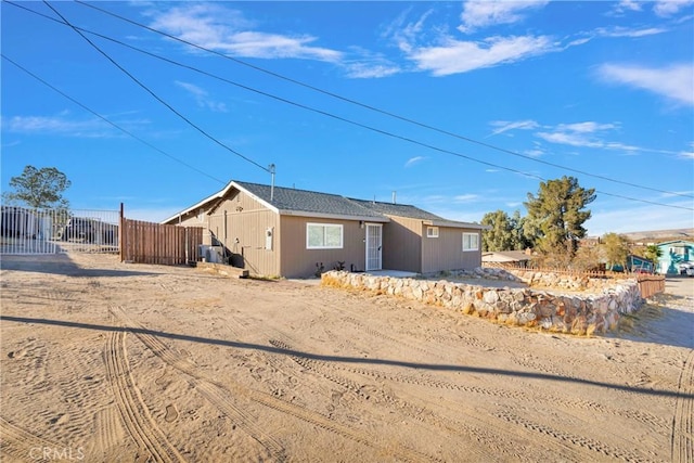 ranch-style home featuring fence