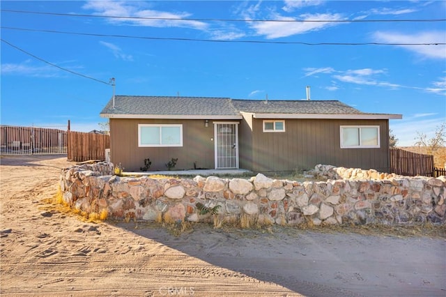 single story home featuring fence