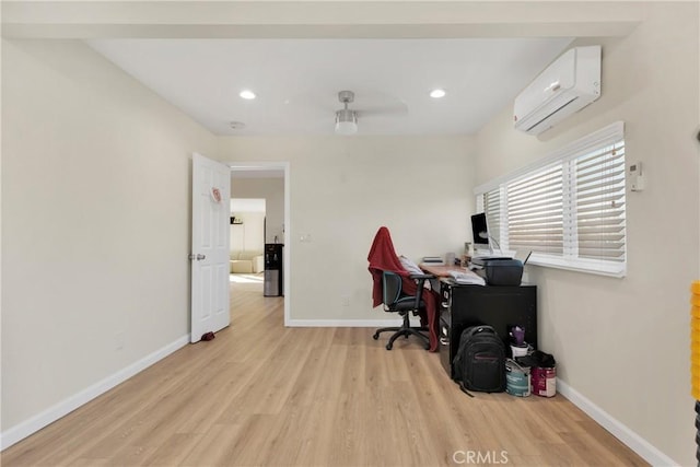 home office featuring light hardwood / wood-style flooring and an AC wall unit