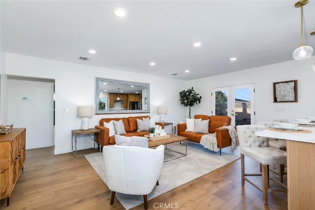 living room with light hardwood / wood-style floors and french doors