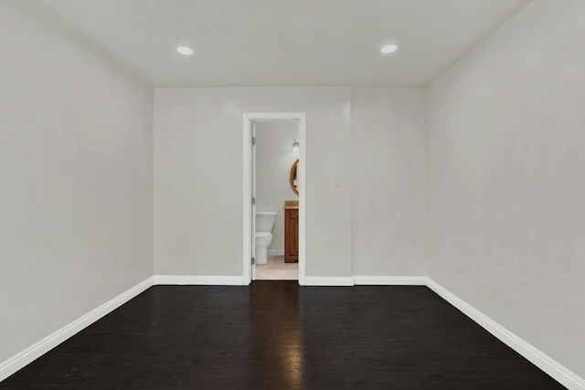 unfurnished room featuring dark hardwood / wood-style flooring