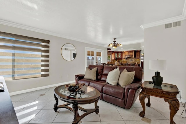 tiled living room featuring crown molding and a notable chandelier