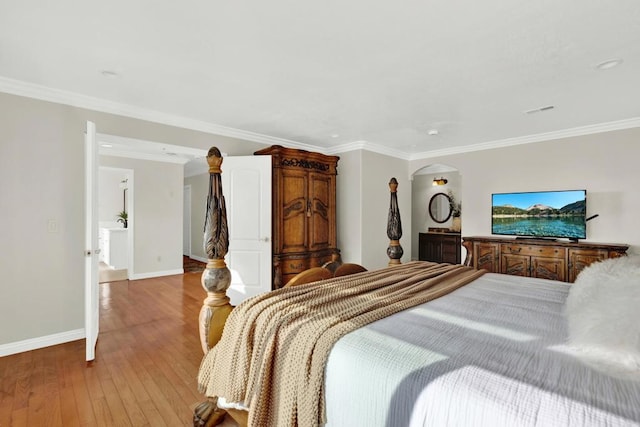 bedroom featuring light hardwood / wood-style floors and crown molding