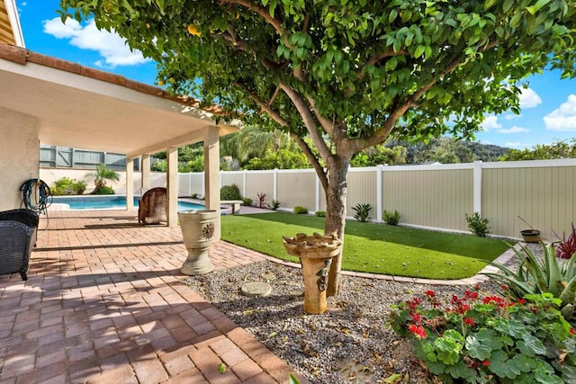 view of patio with a fenced in pool