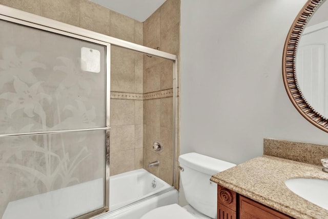 full bathroom featuring shower / bath combination with glass door, vanity, and toilet