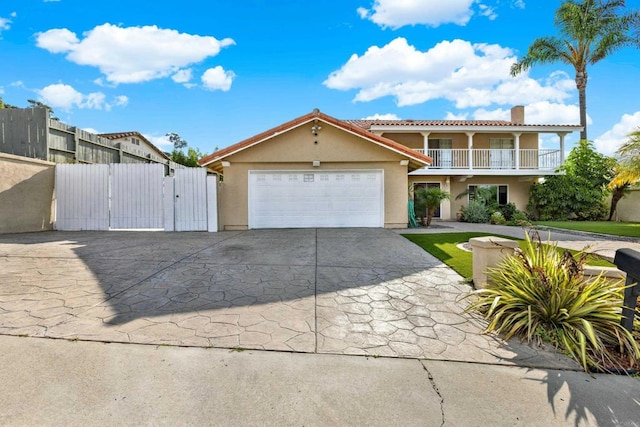 view of front of property featuring a balcony and a garage