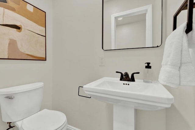 bathroom featuring sink and toilet