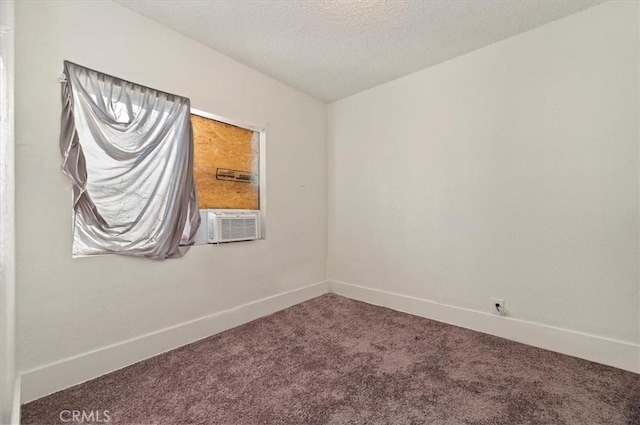 empty room with cooling unit, carpet floors, and a textured ceiling