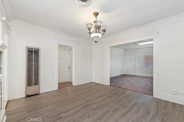 unfurnished room featuring a textured ceiling, dark hardwood / wood-style floors, and an inviting chandelier