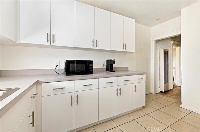 kitchen featuring white cabinets and light tile patterned floors