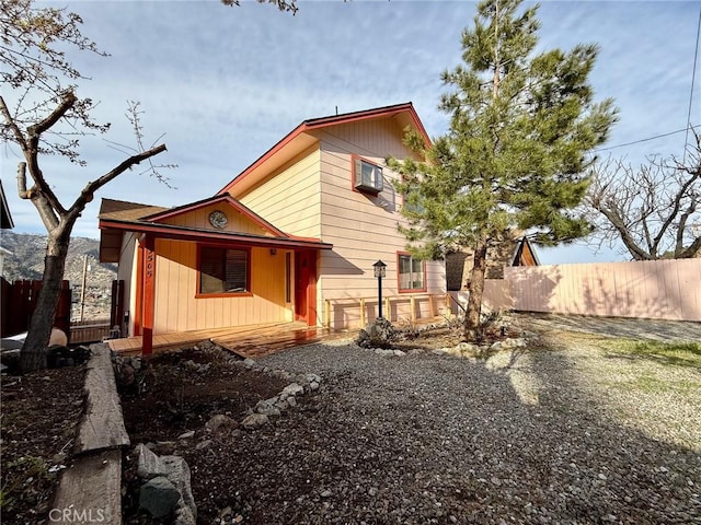 view of side of property featuring fence