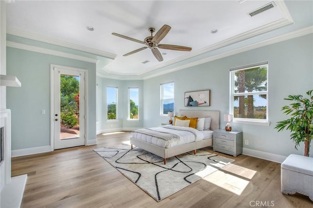 bedroom featuring multiple windows, access to exterior, crown molding, and light wood-type flooring