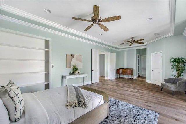 bedroom featuring ceiling fan, ornamental molding, and hardwood / wood-style floors