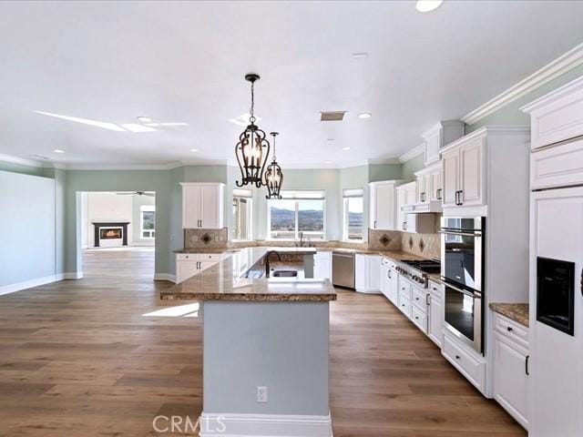 kitchen featuring white cabinetry, a kitchen island, and appliances with stainless steel finishes