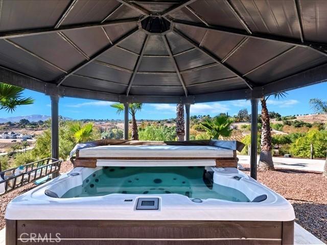 view of patio / terrace featuring a gazebo and a hot tub