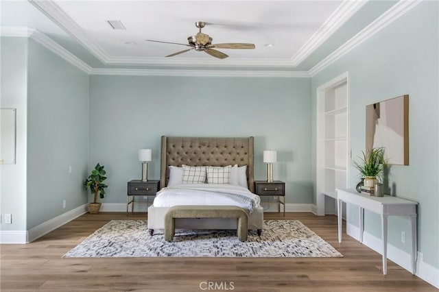 bedroom with crown molding, ceiling fan, and light hardwood / wood-style floors