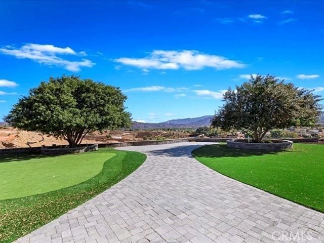 surrounding community featuring a mountain view and a yard