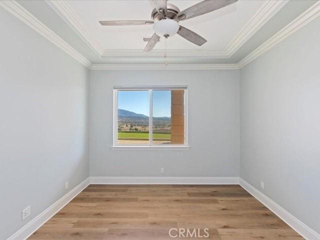 spare room with ornamental molding, ceiling fan, and light hardwood / wood-style floors