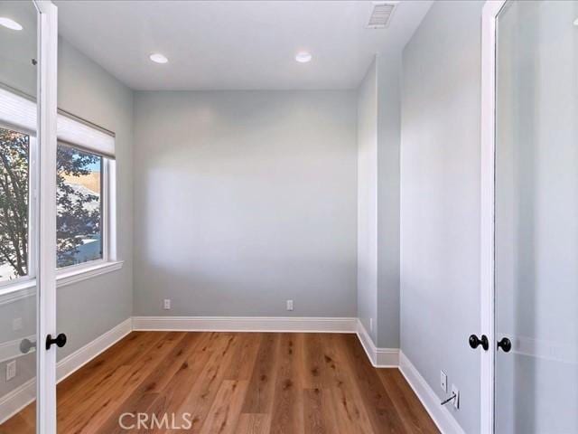 unfurnished room with hardwood / wood-style floors