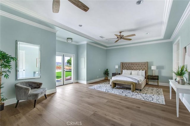 bedroom featuring hardwood / wood-style flooring, ceiling fan, ornamental molding, and access to exterior