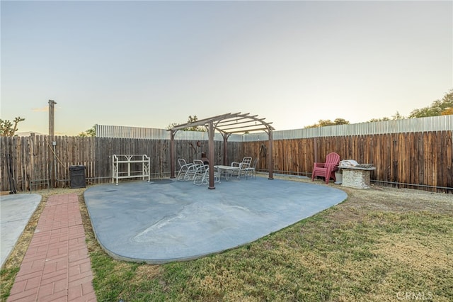 yard at dusk featuring a patio area