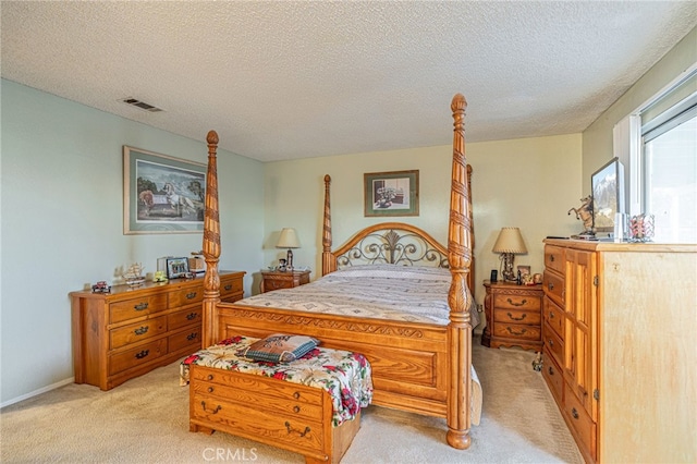 bedroom featuring light carpet and a textured ceiling