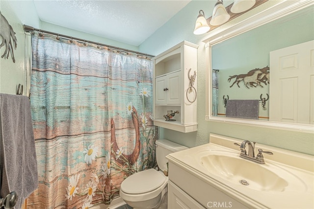 bathroom featuring a shower with curtain, vanity, toilet, and a textured ceiling