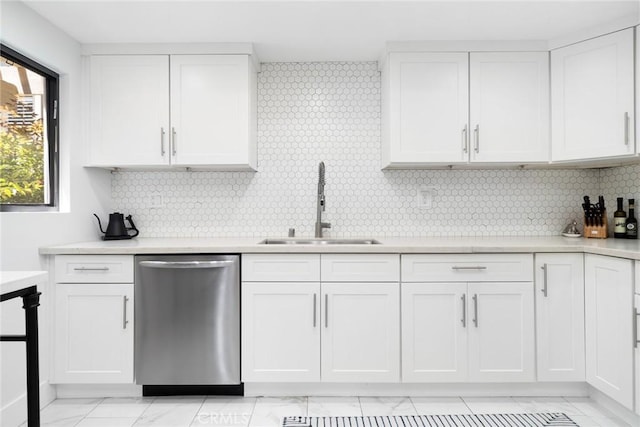 kitchen with dishwasher, backsplash, white cabinets, and sink