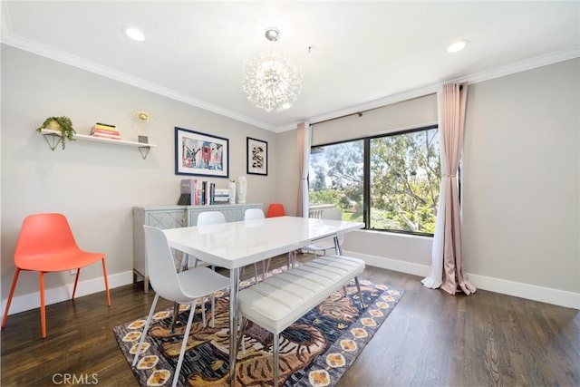 dining area featuring dark hardwood / wood-style floors, crown molding, and a notable chandelier