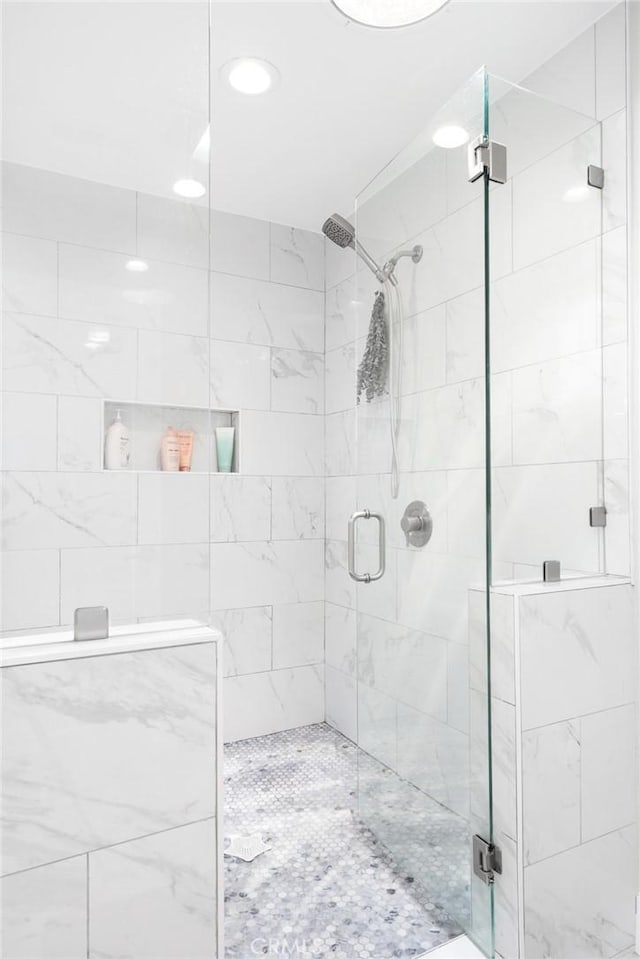 bathroom with a shower with shower door