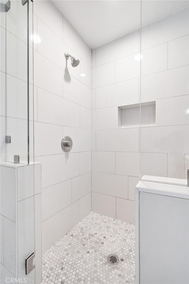 bathroom with a tile shower