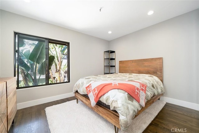 bedroom with dark hardwood / wood-style flooring