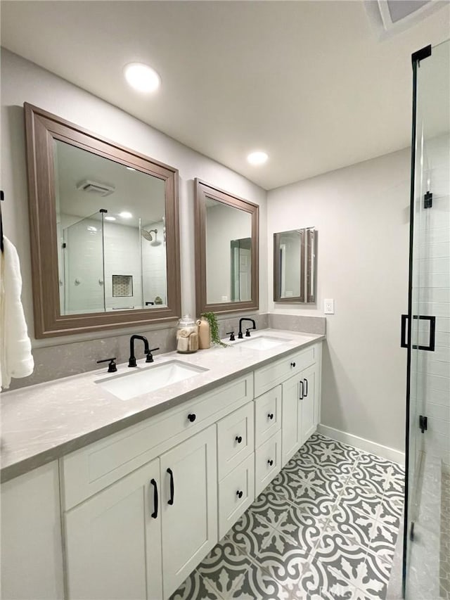 bathroom with tile patterned floors, vanity, and walk in shower